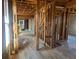 Stripped interior showcasing original hardwood floors, exposed brick, and framing for remodeling at 241 W 4Th Ave, Denver, CO 80223