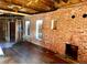 Living room features exposed brick walls, new windows, and fireplace ready to be transformed at 241 W 4Th Ave, Denver, CO 80223