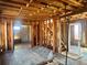 Unfinished living room showcases hardwood floors, exposed brick wall, and staircase needing renovation at 241 W 4Th Ave, Denver, CO 80223