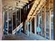 A living room reveals a staircase, exposed ceiling, hardwood floors, and brick needing renovation at 241 W 4Th Ave, Denver, CO 80223