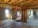 Unfinished living room reveals hardwood floors, exposed ceiling, and staircase awaiting renovation at 241 W 4Th Ave, Denver, CO 80223