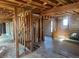 Exposed living room under construction with hardwood floors, brick fireplace, and stairs framework at 241 W 4Th Ave, Denver, CO 80223