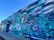 Artistic mural with geometric and abstract designs in blue and purple, enhancing building's curb appeal at 241 W 4Th Ave, Denver, CO 80223