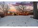 Large backyard with snowy ground and a deck for winter enjoyment at 8261 Delaware St, Denver, CO 80221