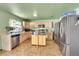 Well-lit kitchen with stainless steel appliances, an island, and ample counter space at 5214 Perth Ct, Denver, CO 80249