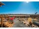 This backyard features a fire pit with red Adirondack chairs and a wooden deck at 6812 Indian Paintbrush St, Frederick, CO 80530