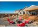 Cozy backyard firepit area with red Adirondack chairs and a wood deck at 6812 Indian Paintbrush St, Frederick, CO 80530