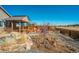Exterior view of a wood deck and the cozy backyard firepit area with red Adirondack chairs at 6812 Indian Paintbrush St, Frederick, CO 80530