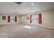Spacious basement with carpet and natural light streaming through three windows at 6812 Indian Paintbrush St, Frederick, CO 80530