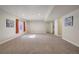 Expansive carpeted basement with ample lighting and stairs at 6812 Indian Paintbrush St, Frederick, CO 80530