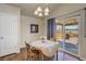 Bright dining area features hardwood floors and a sliding door leading to an outdoor deck at 6812 Indian Paintbrush St, Frederick, CO 80530