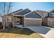 Charming home with a two-car garage, stone accents, and a covered front porch at 6812 Indian Paintbrush St, Frederick, CO 80530