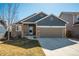 Charming single Gathering home featuring a two-car garage, covered porch, and well-maintained front yard at 6812 Indian Paintbrush St, Frederick, CO 80530
