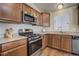 Well-equipped kitchen with stainless steel appliances, granite countertops, and hardwood floors at 6812 Indian Paintbrush St, Frederick, CO 80530