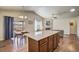 Spacious kitchen with granite island open to the dining area and cozy living space at 6812 Indian Paintbrush St, Frederick, CO 80530