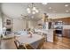 Open-concept kitchen and dining area featuring stainless steel appliances and granite countertops at 6812 Indian Paintbrush St, Frederick, CO 80530
