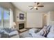 Cozy living area with a fireplace, hardwood floors, and neutral paint tones at 6812 Indian Paintbrush St, Frederick, CO 80530
