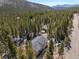 A home among the treetops: aerial showcasing the property in its lush, secluded natural environment at 140 Beaver Rd, Idaho Springs, CO 80452