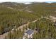 Stunning aerial view featuring the home in a tranquil wooded setting and surrounded by nature at 140 Beaver Rd, Idaho Springs, CO 80452