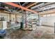 Unfinished basement area with exposed ceiling, concrete floor, and a workbench at 140 Beaver Rd, Idaho Springs, CO 80452