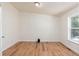 Bright, spacious bedroom with wood-look flooring, a large window with scenic views, and ample natural light at 140 Beaver Rd, Idaho Springs, CO 80452
