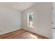 Compact bedroom with laminate flooring, bright white walls, and a window providing natural light at 140 Beaver Rd, Idaho Springs, CO 80452
