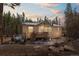 Charming single-story home nestled in a wooded area with a cozy front porch and a beautiful sunset backdrop at 140 Beaver Rd, Idaho Springs, CO 80452
