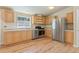 Modern kitchen with stainless steel appliances, light wood cabinets, and a bright window offering lovely views at 140 Beaver Rd, Idaho Springs, CO 80452