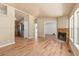 Spacious living room featuring a stone fireplace, wood floors, and abundant natural light with an open concept at 140 Beaver Rd, Idaho Springs, CO 80452