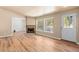 Bright living room with wood floors, a stone fireplace, and large windows overlooking the picturesque outdoor view at 140 Beaver Rd, Idaho Springs, CO 80452