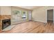 Comfortable living space with wood flooring, a stone fireplace, and large windows offering scenic views of the outdoors at 140 Beaver Rd, Idaho Springs, CO 80452