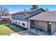 Spacious backyard with mature trees, a patio area and covered entry at 7017 W 62Nd Pl, Arvada, CO 80003