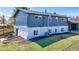 Spacious backyard with mature trees, a patio area, and new black mulch at 7017 W 62Nd Pl, Arvada, CO 80003