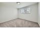 Clean bedroom with neutral carpet, fresh paint and a large window offering natural light at 7017 W 62Nd Pl, Arvada, CO 80003