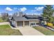 Charming exterior view of home with a large front yard, covered porch and two car garage at 7017 W 62Nd Pl, Arvada, CO 80003