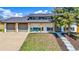 Charming exterior view of home with a large front yard, covered porch and two car garage at 7017 W 62Nd Pl, Arvada, CO 80003