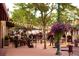 Charming outdoor patio view with string lights, lush greenery, and a lively dining atmosphere for relaxing evenings at 7017 W 62Nd Pl, Arvada, CO 80003