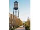 Scenic street view featuring the iconic 'Arvada' water tower, nestled among trees and historic buildings at 7017 W 62Nd Pl, Arvada, CO 80003