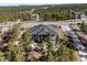 A modern home nestled among trees with a private driveway and lush surrounding landscape at 445 Panoramic Dr, Monument, CO 80132