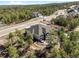 An aerial view of a large modern home surrounded by lush trees and a long private driveway at 445 Panoramic Dr, Monument, CO 80132