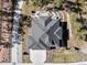 An aerial top-down view of a home, revealing the roofline, driveway, and surrounding landscape at 445 Panoramic Dr, Monument, CO 80132
