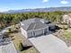 Expansive aerial view of the estate showcasing its grand scale, landscaping, and mountain views at 445 Panoramic Dr, Monument, CO 80132