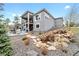 Stunning backyard oasis features a tranquil waterfall, lush greenery, and a serene seating area at 445 Panoramic Dr, Monument, CO 80132