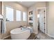 Bathroom with a large soaking tub and decorative recessed shelves at 445 Panoramic Dr, Monument, CO 80132