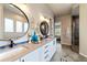 Bright bathroom features a double vanity, modern fixtures, and large round mirrors at 445 Panoramic Dr, Monument, CO 80132