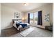 Cozy bedroom with a soft bed, carpeted floors, and natural light from windows at 445 Panoramic Dr, Monument, CO 80132