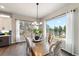 Dining room with large windows, hardwood floors, and a modern chandelier at 445 Panoramic Dr, Monument, CO 80132