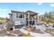 A two-story home with a walkout basement, outdoor living space, and a hot tub at 445 Panoramic Dr, Monument, CO 80132