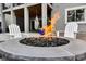A modern backyard with a stone fire pit and Adirondack chairs for relaxing outdoors at 445 Panoramic Dr, Monument, CO 80132