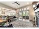 Spacious living room featuring a stone fireplace, large sliding doors, and ample natural light for a bright atmosphere at 445 Panoramic Dr, Monument, CO 80132